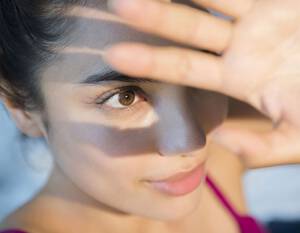 Woman shielding eyes from sun